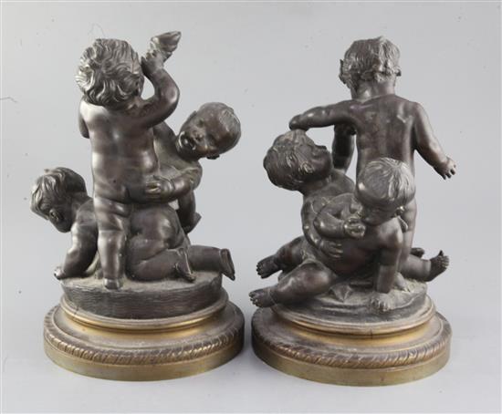 A pair of 19th century bronze groups of wrestling putti, height 10.75in.